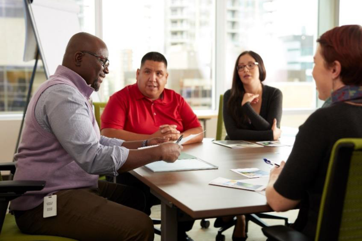 Four people having a discussion at a table