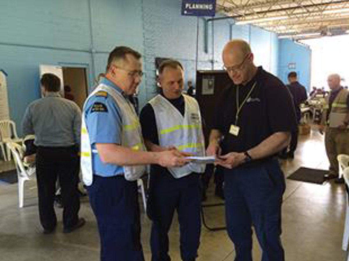 Three people at an emergency response exercise