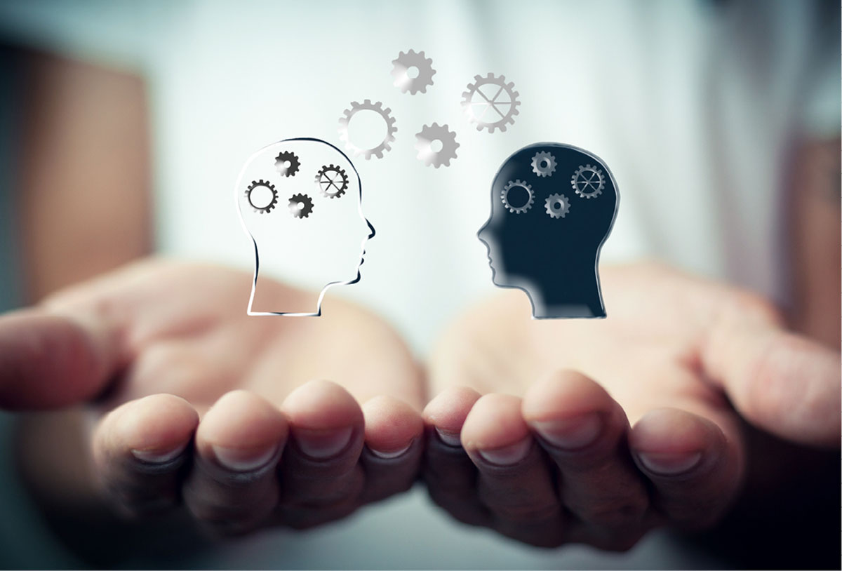 Two figures exchanging ideas on a pair of open facing hands.