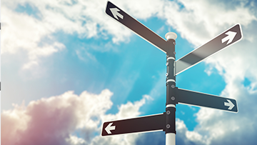 A sign post with four arrows pointing in different directions