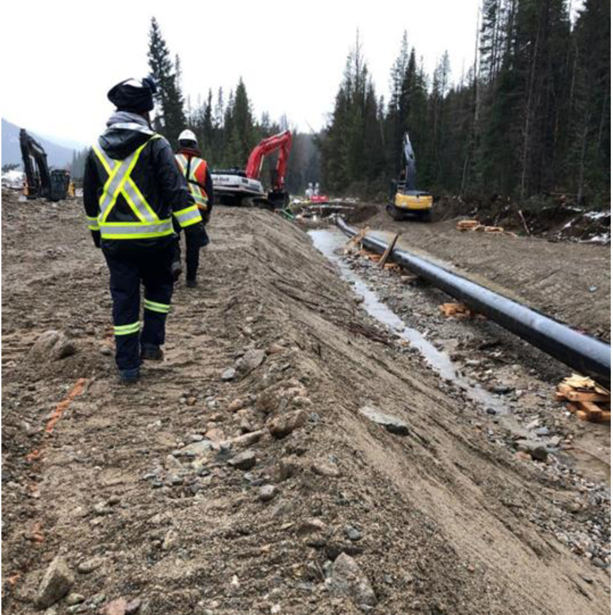 Figure&nbsp;5 &ndash; CER Inspectors walking alongside an exposed length of the pipeline.