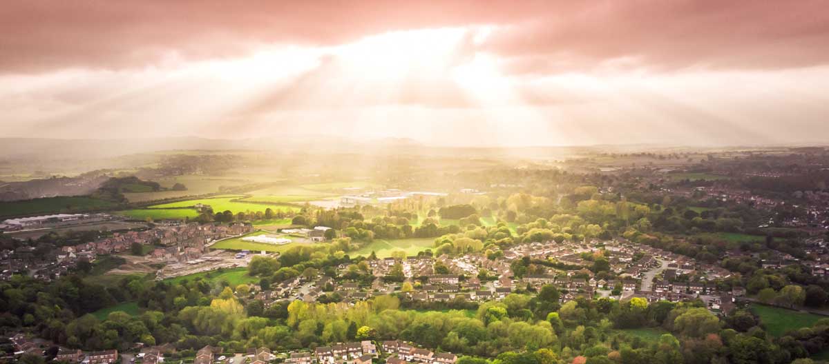 Figure&nbsp;2 &ndash; Rays of sunshine over a mix of urban developments and agricultural lands.