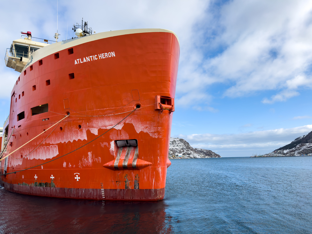 St. John's, Newfoundland, the Atlantic Heron is a supply vessel for St. John's offshore oil industry in the Hibernia oil field. St. John's harbour entrance is in the background.