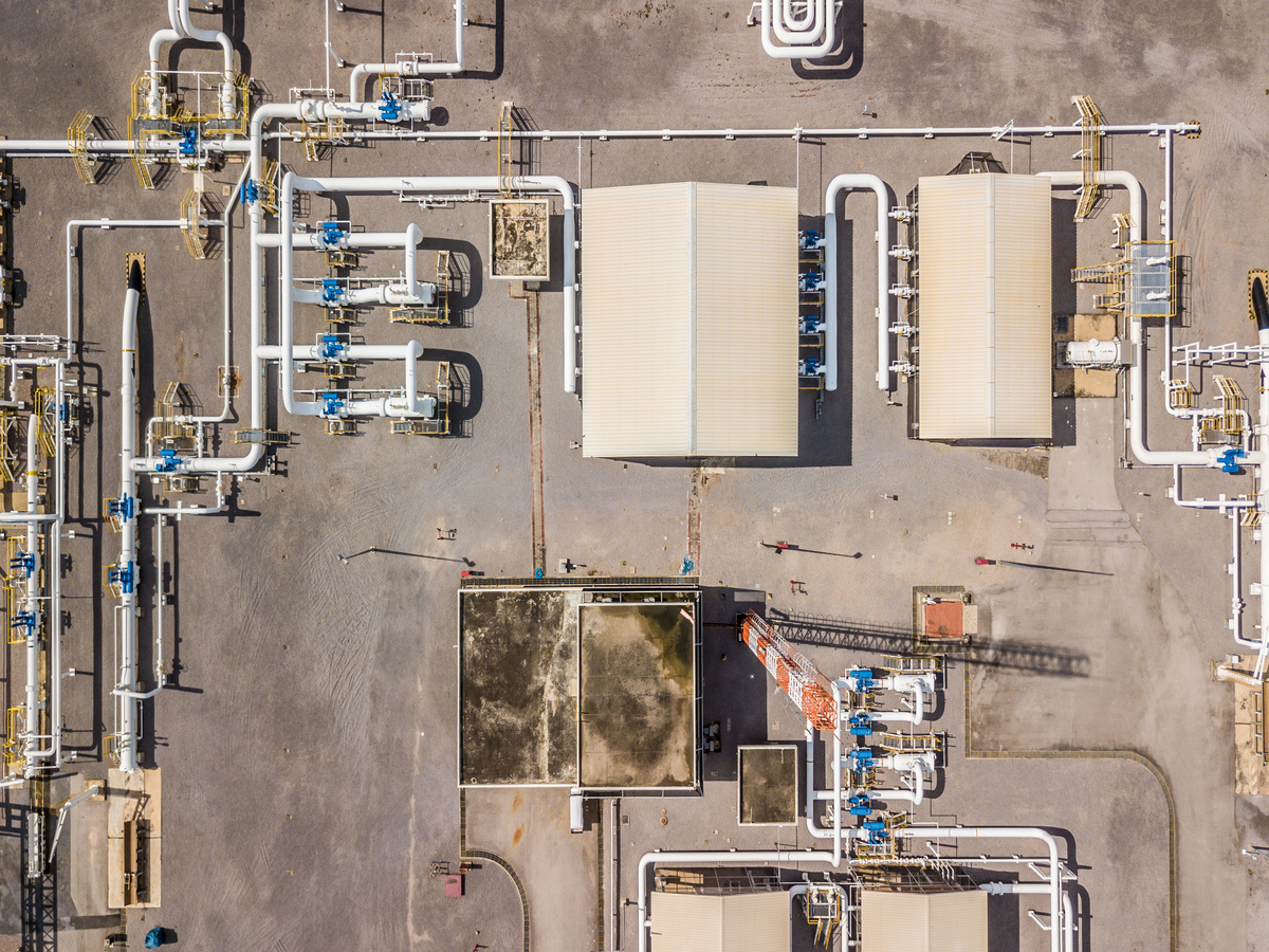Aerial top view natural gas pipeline, gas industry, gas transport system, stop valves and appliances for gas pumping station.