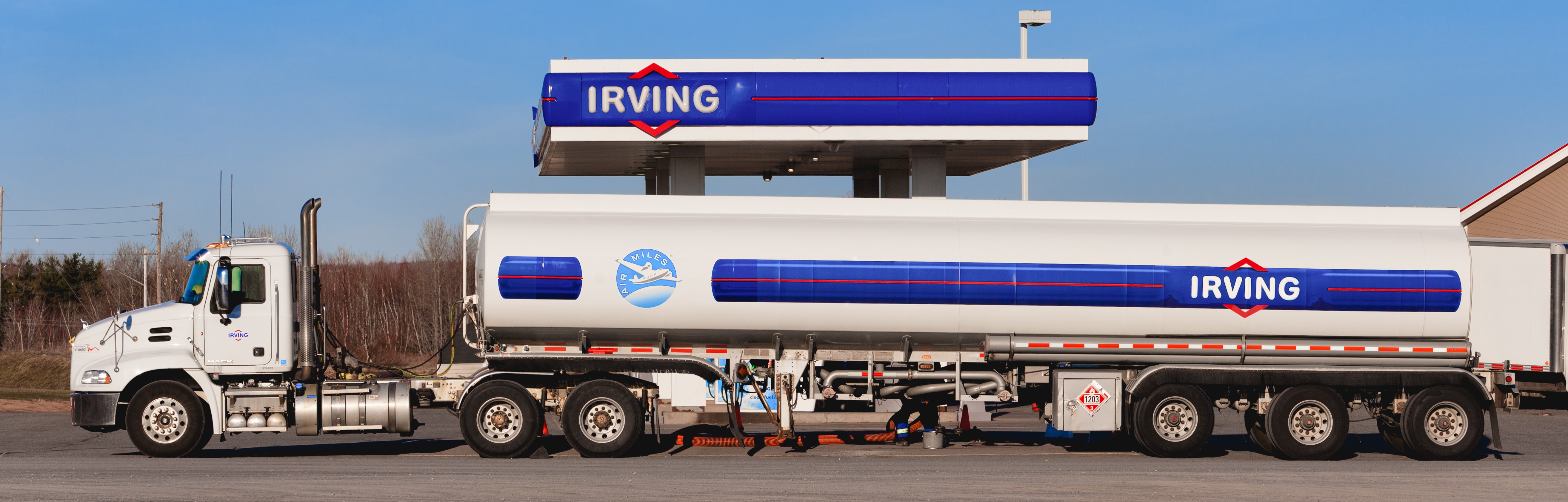 Westville, Canada, an Irving Oil delivery truck outside gas station. Irving Oil Ltd. is a Canadian company which produces, sells and exports gasoline, oil and natural gas.