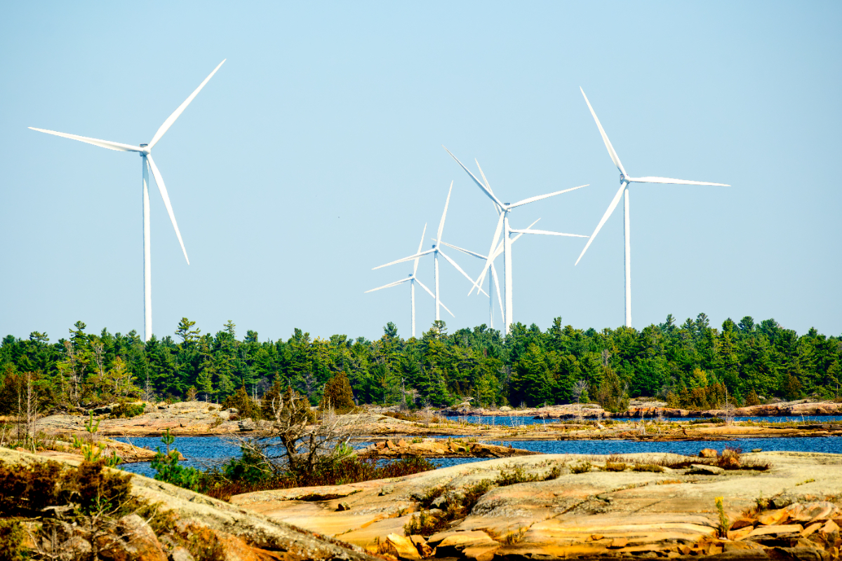 Wind turbines photographed in autumn on the shore of Georgian bay, a project of the Henvey Inlet First Nation.