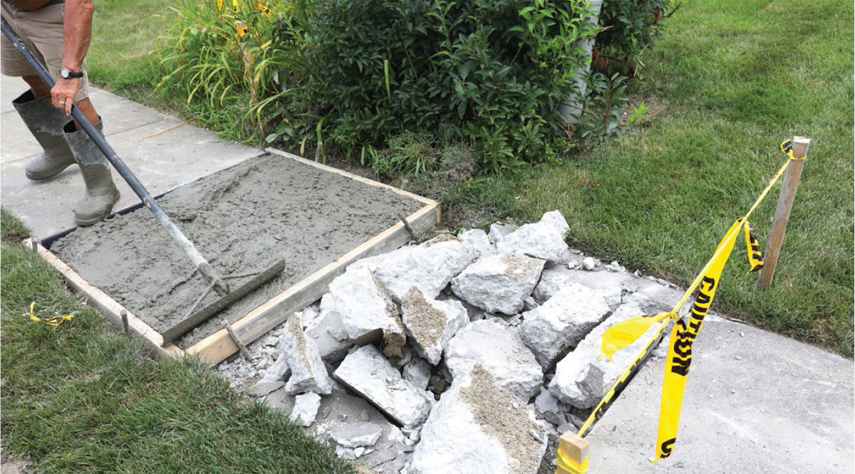 Person working on sidewalk repair